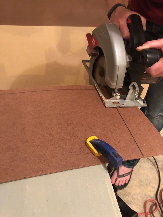 Use a circular saw to cut the hardboard into custom pieces for your accent wall. 
