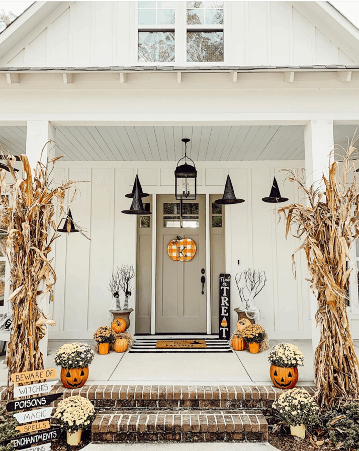 Create a spooky front porch for fall by decorating with witch hats. 