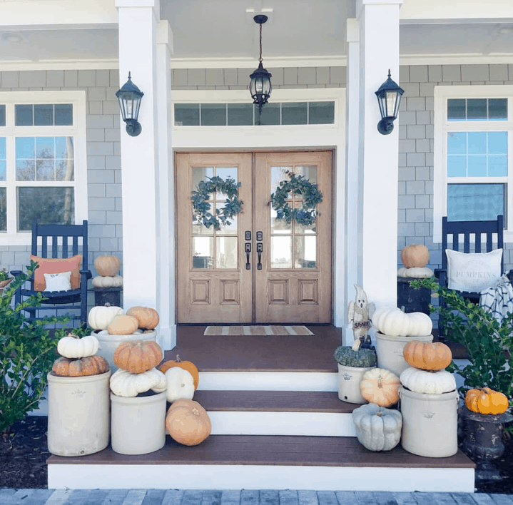 Create height and dimension by stacking pumpkins on buckets for your fall outdoor space decorations. 