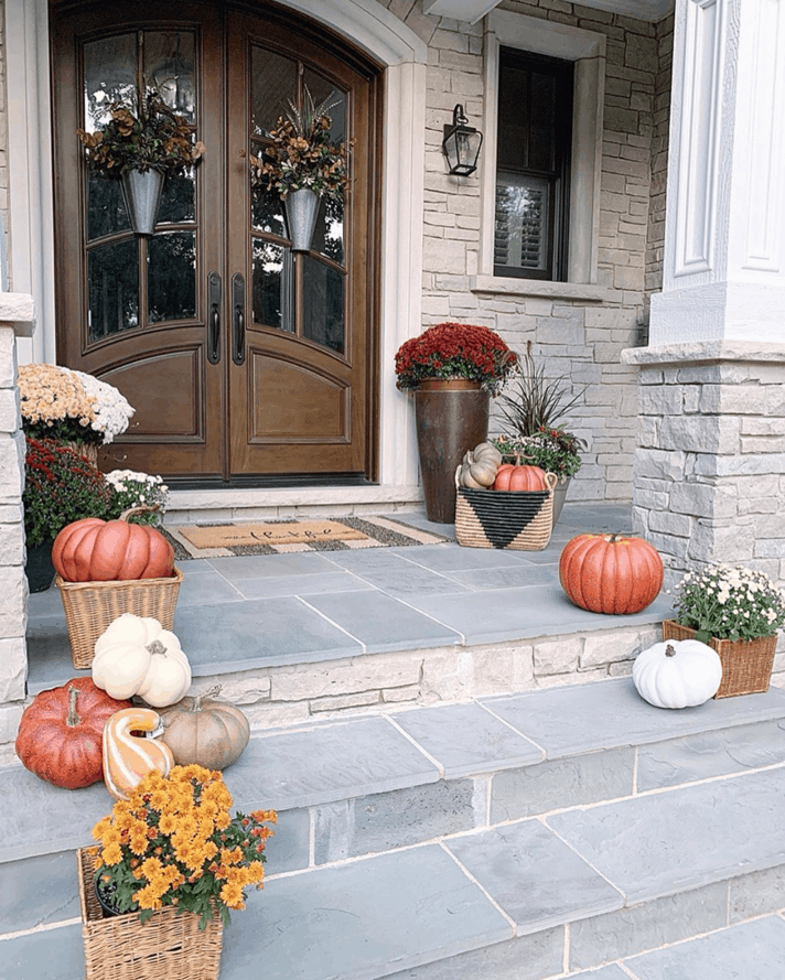 Add texture to your front porch for fall by decorating with wicker baskets. 