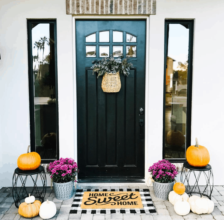 A fall decorating idea is to layer your front porch door mat with a rug. 