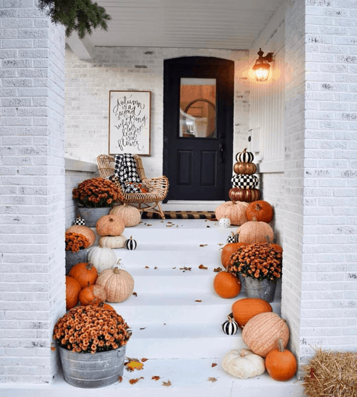 Paint your pumpkins black and white to add a pop of color to your fall front porch. 