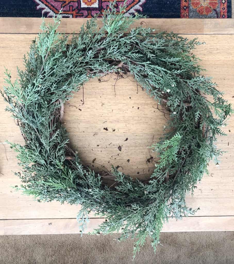 DIY Christmas Wreath Tutorial using faux pine stems, eucalyptus, ribbon and brass bells. 