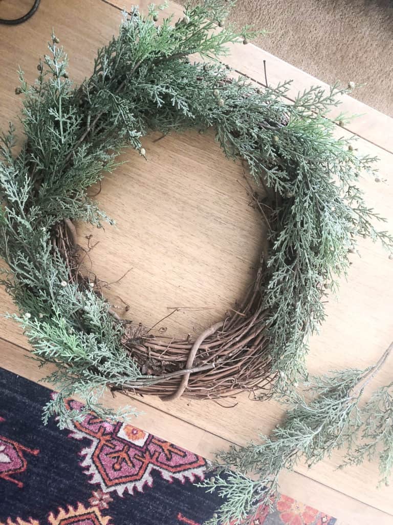 Frame your Hobby Lobby grapevine wreath with the faux pine stems until covered all around. 