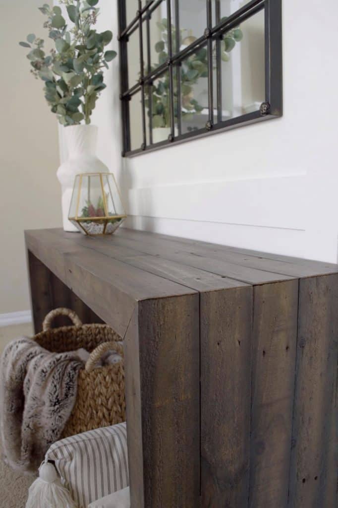 There are variations in color and texture throughout the console table. 