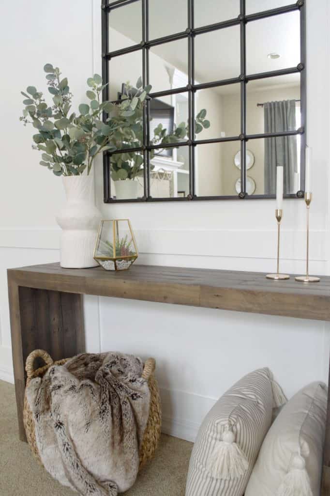 With white walls, you can warm it up by adding wood furniture, wicker baskets, brass decor and greenery. 