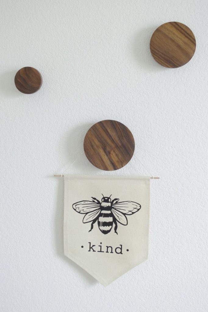 I love these modern wood dot coat hooks and Etsy canvas sign for a nursery. 