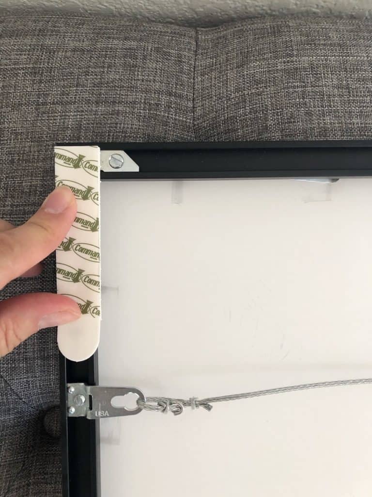 Press your command strips along your frame. 