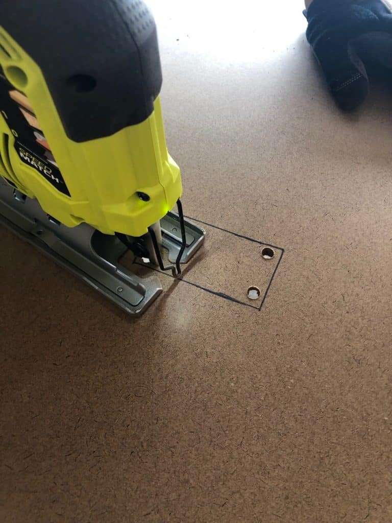 Use a jigsaw to cut the hole for your outlet. 