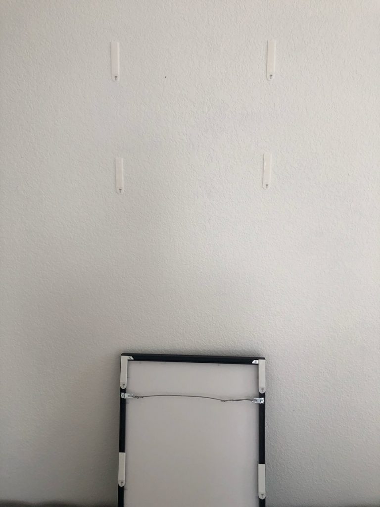 Allow the command hanging strips to set for 1 hr before placing your frame back onto the wall. 
