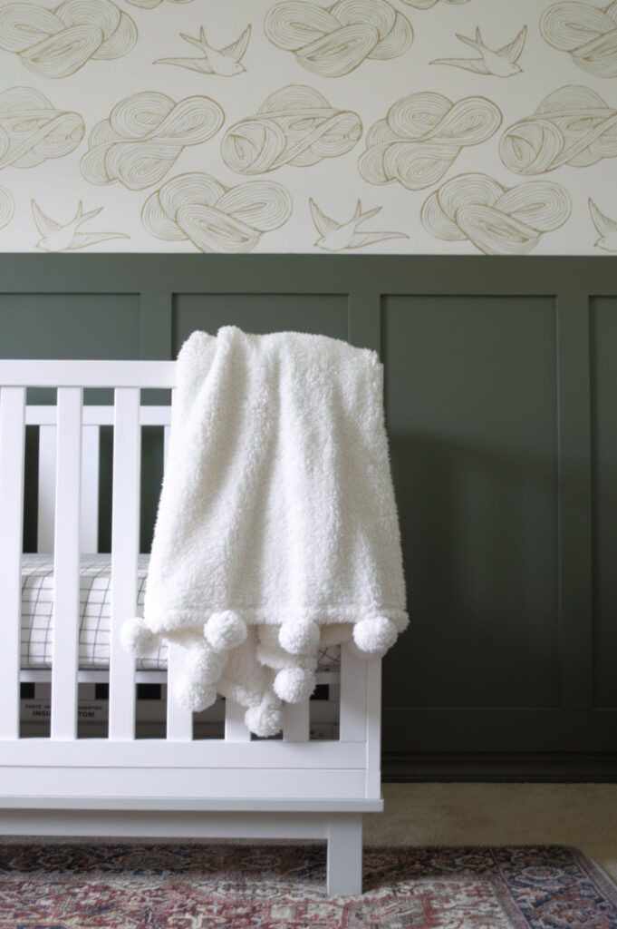Modern and Vintage baby boy nursery with a board and batten accent wall painted in Benjamin Moore's Backwoods. 